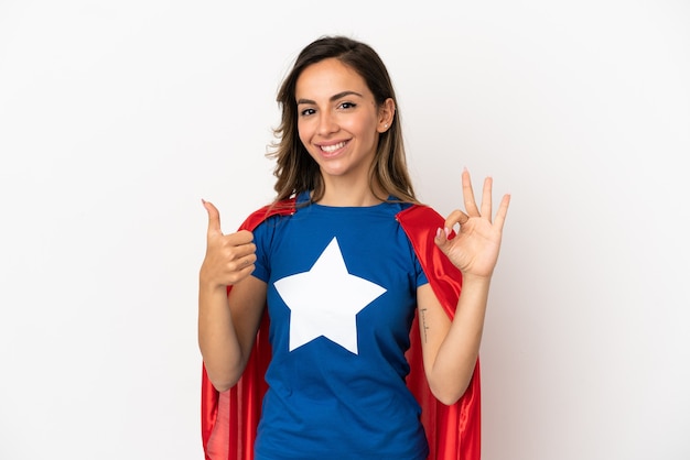 Super Hero woman over isolated white background showing ok sign and thumb up gesture