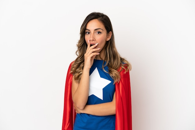 Super Hero woman over isolated white background surprised and shocked while looking right