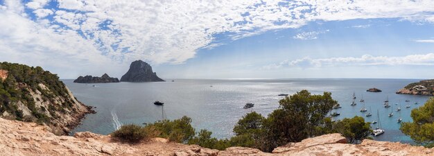 Super panoramic view of bay yellow rocks surrounding the bay Cola d'Hort Ibiza Balearic Islands