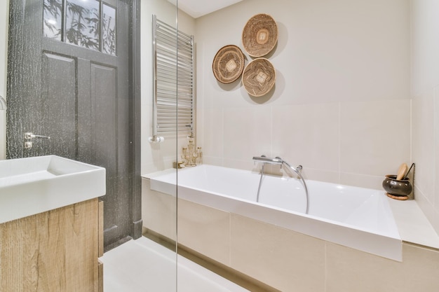 Superb bathroom in beige tones with large cozy bathtub