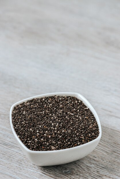 Superfood in a ceramic bowl. Chia seeds. Vertical image.