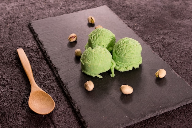 Superfood pistachio ice cream on rustic wooden board