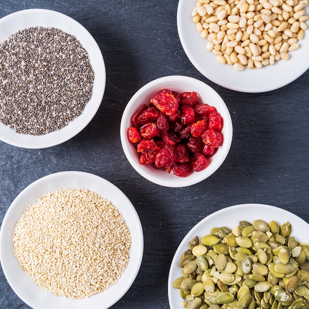 Superfoods in Bowls on blue Background.