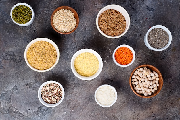 Superfoods and cereals selection in bowls on grey concrete background