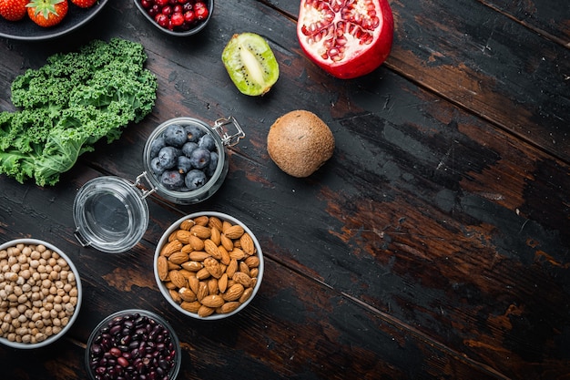 Superfoods dieting clean concept, top view on dark wooden table.