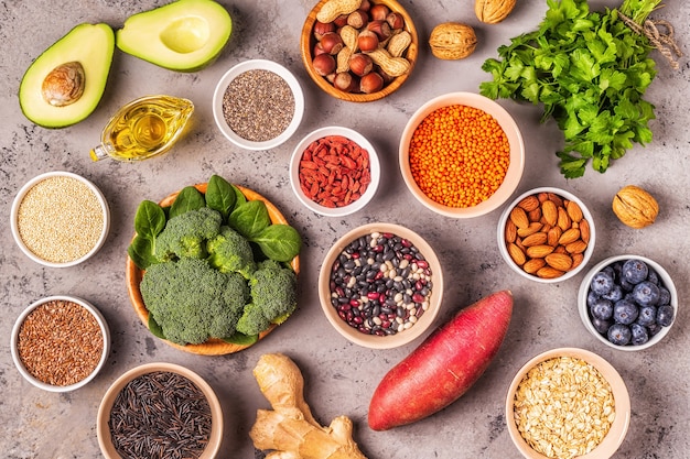 Superfoods on gray concrete background. Healthy food clean eating concept. Top view.