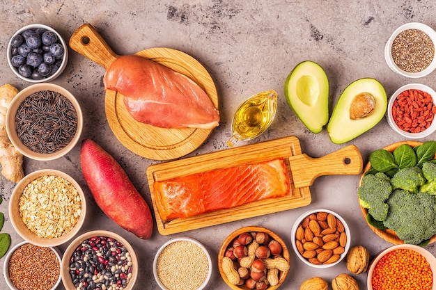 Superfoods on gray concrete background. Healthy food clean eating concept. Top view.