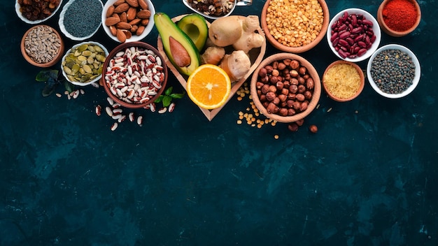 Superfoods Healthy food Nuts berries fruits and legumes On a black stone background Top view Free copy space