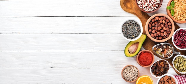 Superfoods Healthy food Nuts berries fruits and legumes On a white wooden background Top view Free copy space