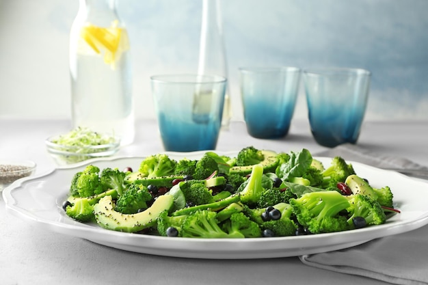 Superfoodsalade met avocadobonen en broccoli op witte keramische plaat in de keuken