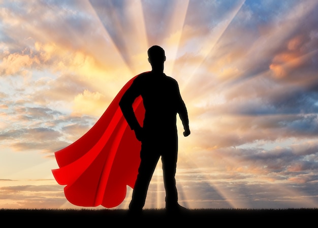 スーパーヒーロービジネスマンスーパーヒーロー。日没時の自信と強いビジネスマンのスーパーヒーローのシルエット