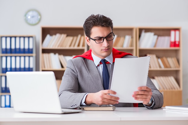 Superhero businessman working in the office