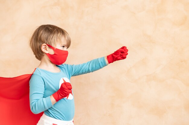 Photo superhero child fighting coronavirus covid-19 pandemic concept