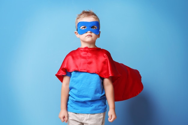 Superhero kid on blue background