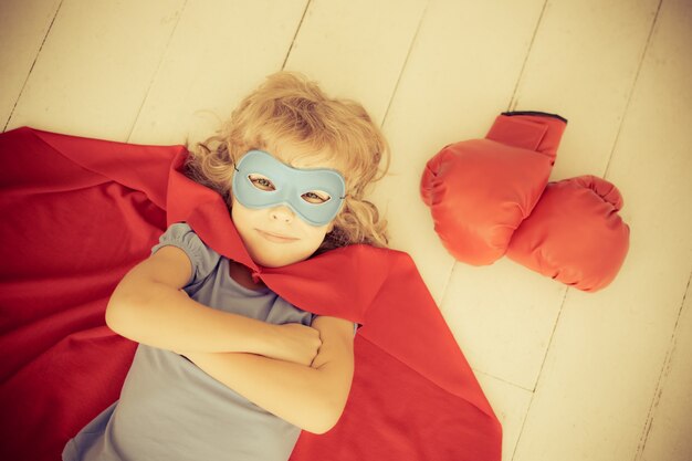 Superhero kid with red boxing gloves. Retro toned