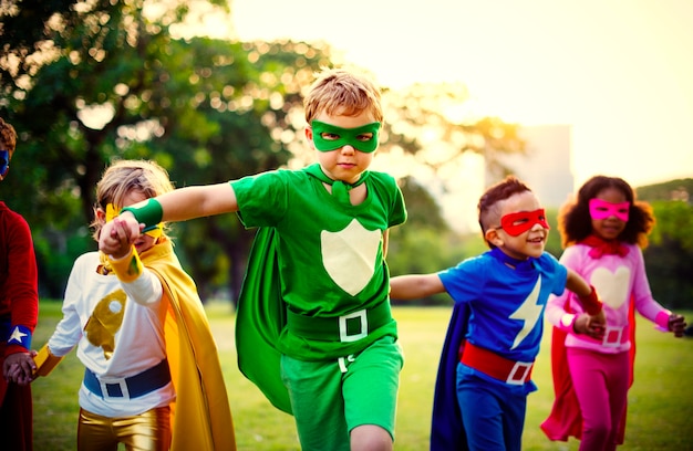 Superhero kids having fun and playing together