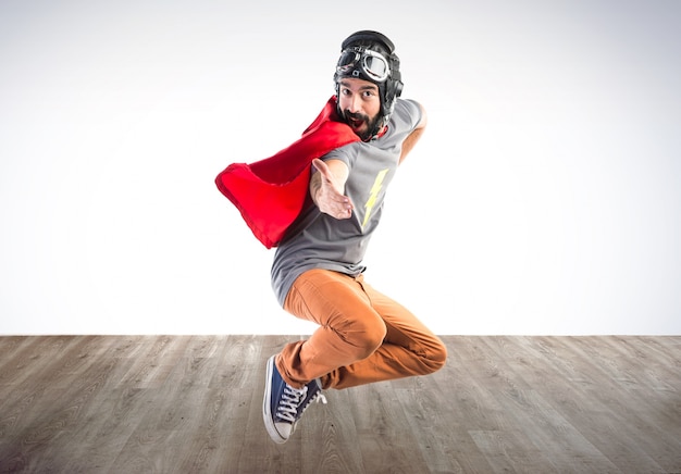 Superhero saluting on colorful background