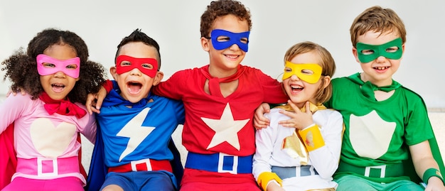 Amici dei bambini dei supereroi che giocano concetto di divertimento di unità