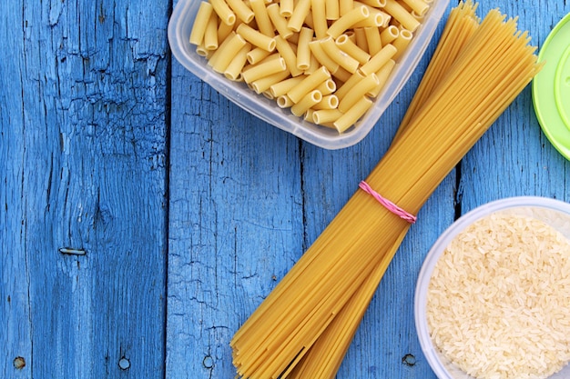 SUPERIOR VIEW OF ITALIAN PASTA ON BLUE BACKGROUND WITH TEXTURE