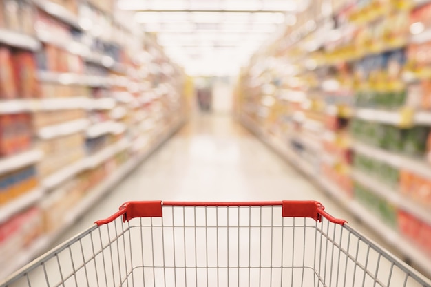 Supermarket aisle with empty shopping cart