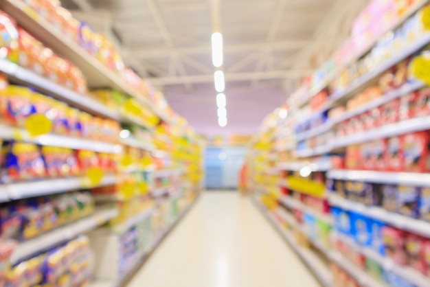 Supermarket aisle with product shelves interior defocused blur