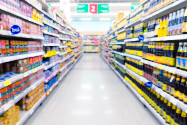 Supermarket aisle with products on shelves. Defocused background.