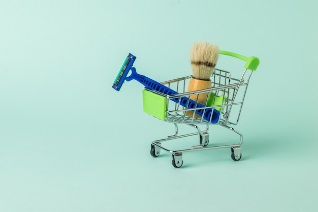 A supermarket cart filled with shaving supplies. Set for care of a man's face.