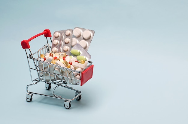 Supermarket cart full of blister pills a bunch of pills in a wheelbarrow