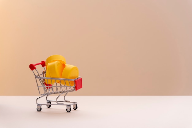 Supermarket cart full of yellow plastic, to recycle