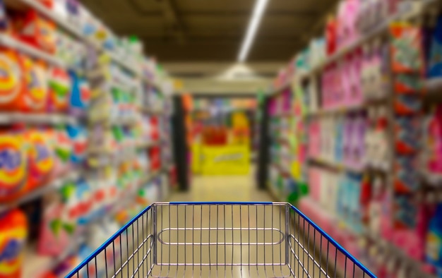 Supermarket corridor with blue shopping cartxA