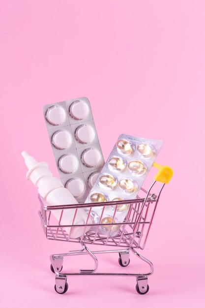 A supermarket trolley full of blister pills a lot of pills in wheelbarrow nasal spray home delivery