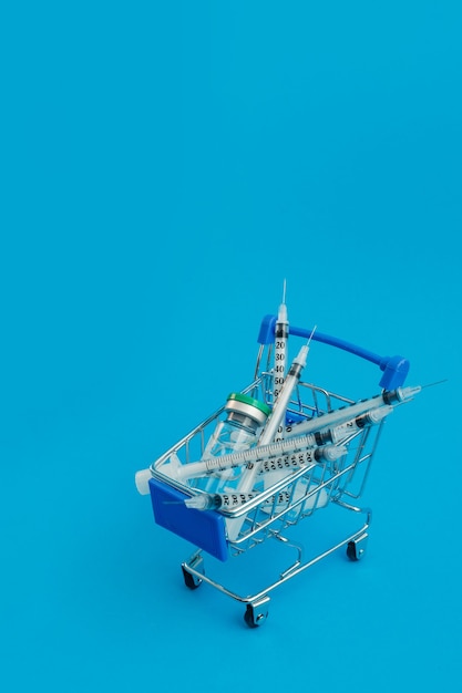 Supermarket trolley with syringes and ampoule isolated