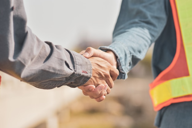 Supervisor building teamwork partnership gesture and people concept handshake on construction site