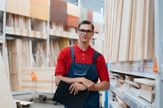 Supervisor with a clipboard standing in the warehouse of a flooring store