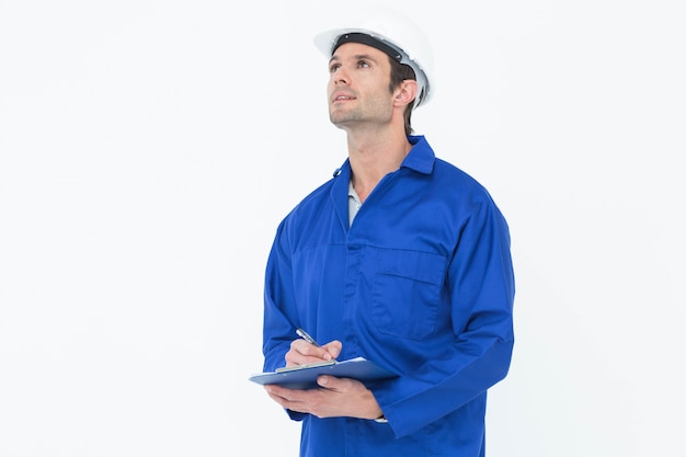 Supervisor writing notes on clip board