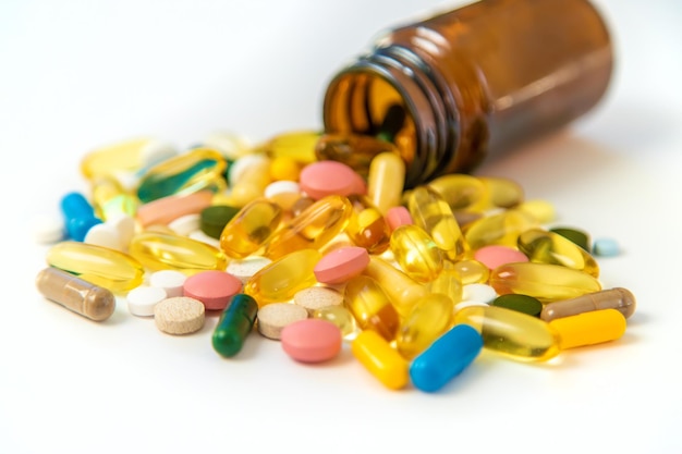 Supplements and vitamins on a white background Selective focus Medicine