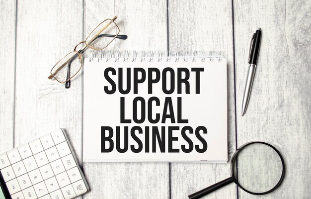 Support local business text on the white notepad