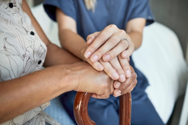 Photo support nurse and holding hands with senior patient for hope empathy and healthcare medical compassion and kindness with closeup of people in nursing home for volunteer help and retirement