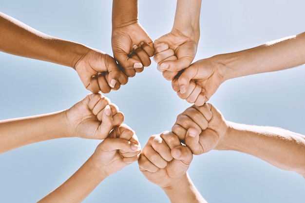 Support trust and solidarity fist hands circle with low angle for loyalty mission and friends with cooperation Connection hope and community of people together for social commitment