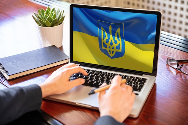 Support ukraine donate help ukrainian people flag on computer\
laptop screen 3d render