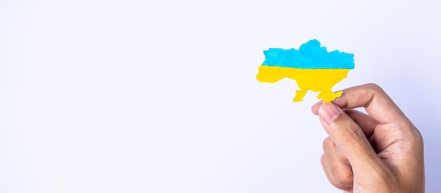 Support for Ukraine in the war with Russia Hands holding the shape of Ukraine border with color flag Pray No war stop war and stand with Ukraine