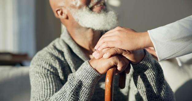 Support walking stick and hands of senior man with a cane for help support and old age caregiver care for patient Healthcare empathy and elderly person in a nursing home for medical health