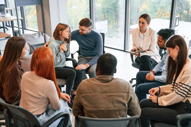 supporting the woman group of people are having therapy meeting together