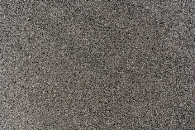 黒い砂のビーチの背景の表面