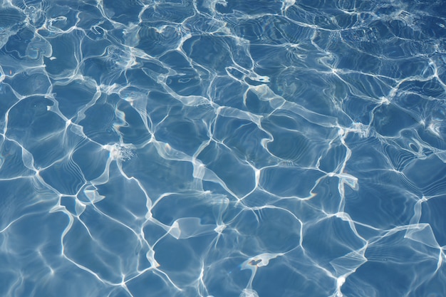 Photo surface of blue swimming pool texture background, water in swimming pool.