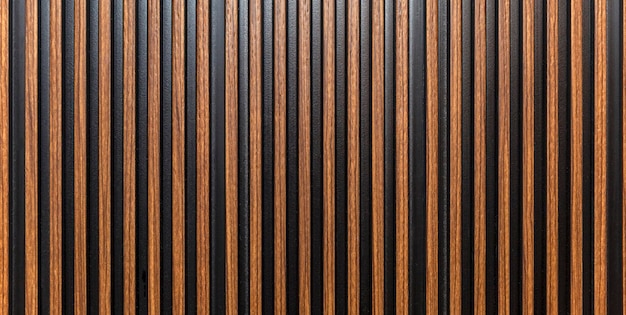 The surface of a brown wooden slatted panel Decor and interior design construction and renovation Space for text Panorama format