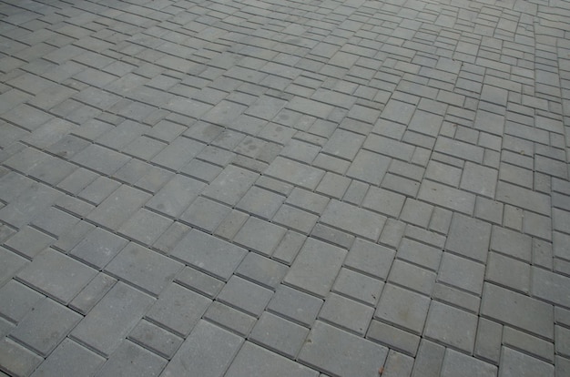 The surface is paved with road tiles of different sizes multi\
format . perspective viewpoint.