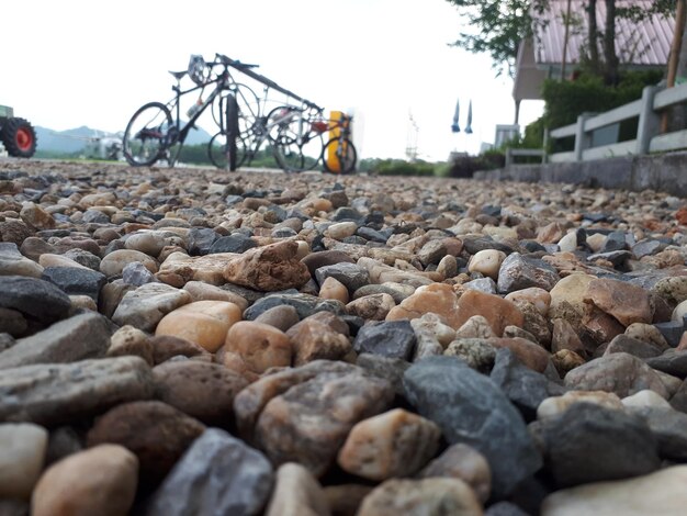 Surface level of pebbles against sky