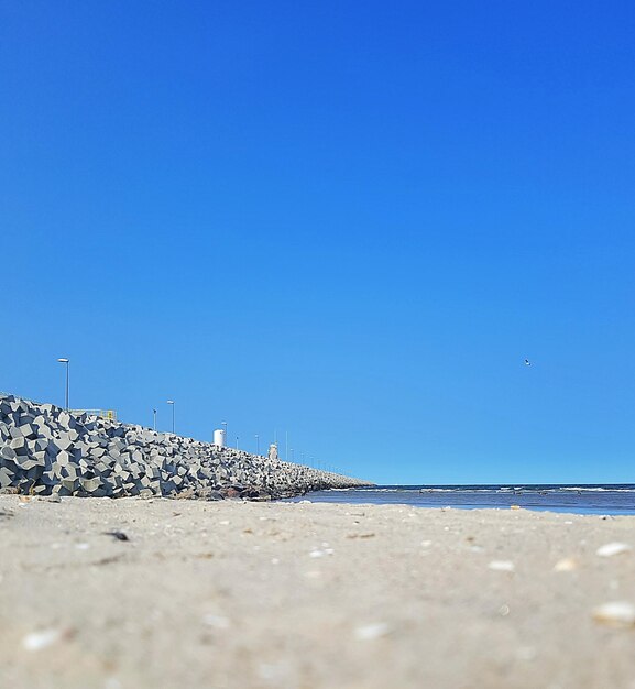 Surface level of sea against clear blue sky