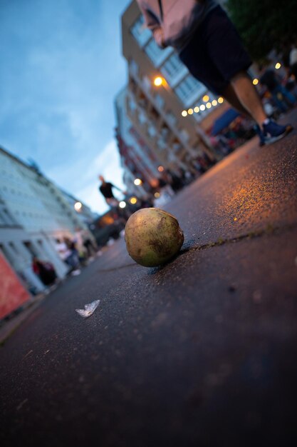 Surface level of strawberry by road against sky in city